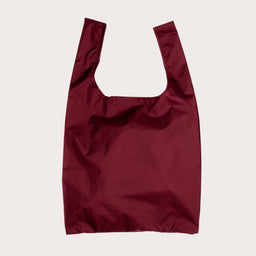 Cherry red reusable shopping bag on a light plain background
