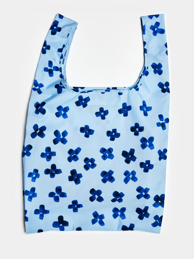 Blue reusable bag with blue flower pattern on a light blue background