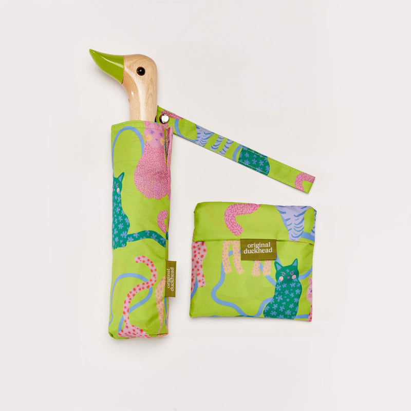 Colourful duck-shaped umbrella with a matching tote bag on a light grey background