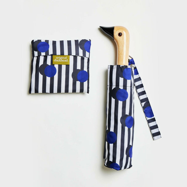 Polka stripe umbrella with a wooden handle, on a white background.