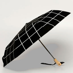 Black umbrella with white grid pattern on a light background
