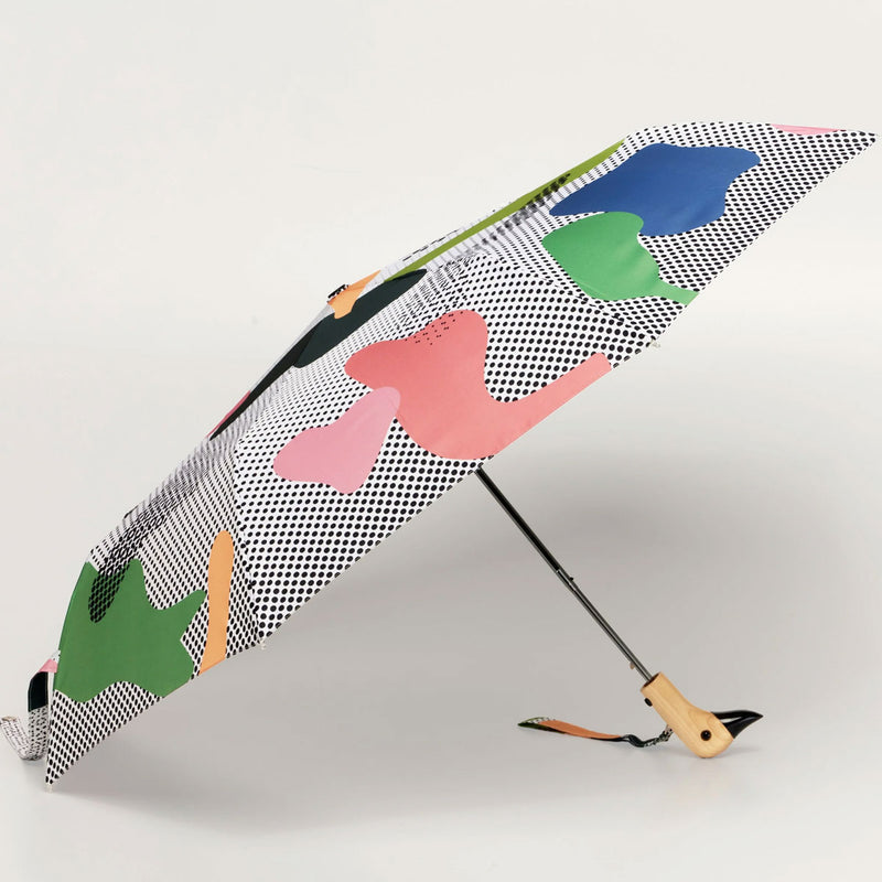 Umbrella with colorful graphic pattern on a light gray background