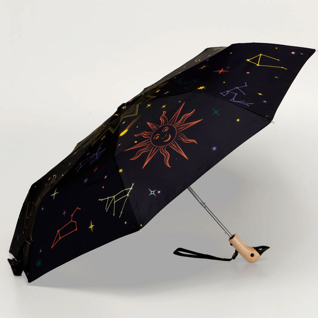 Black umbrella with celestial design on a white background