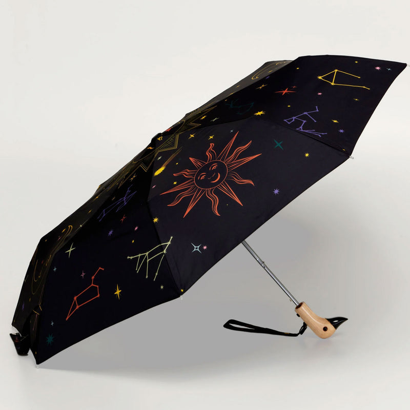 Black umbrella with celestial design on a white background
