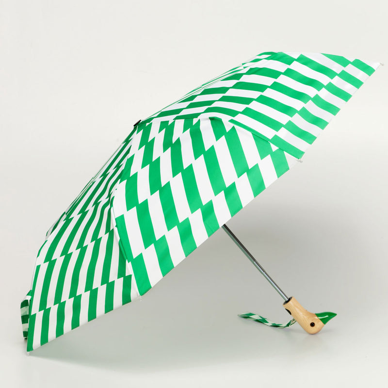 Green and white striped umbrella with a duckhead wooden handle on a light gray background