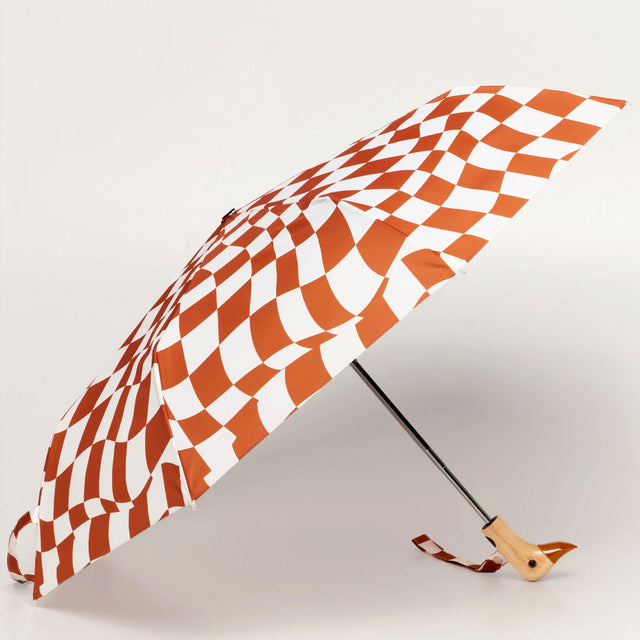 Checkered umbrella with a wooden handle on a light gray background