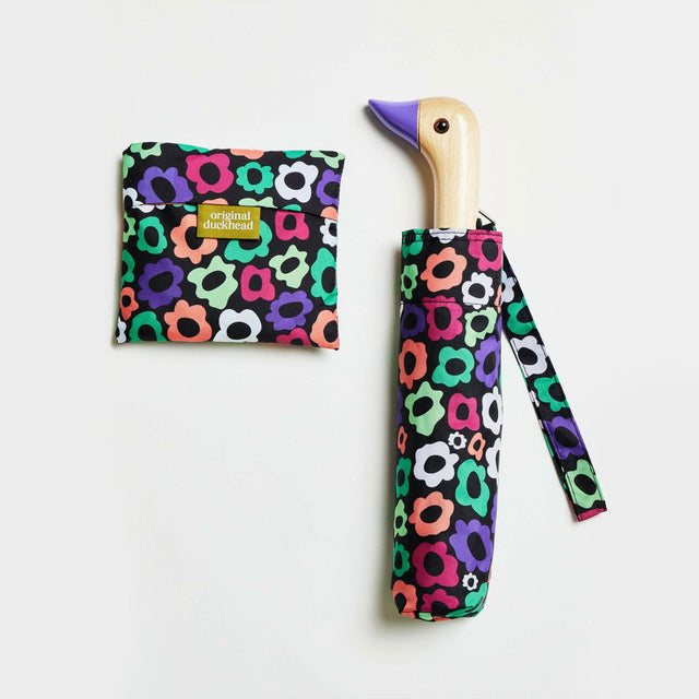 Colorful floral-patterned umbrella with duckhead wooden handle on a white background