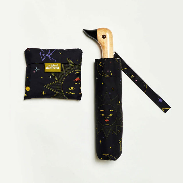 Black umbrella with celestial design and duckhead wooden handle on a white background