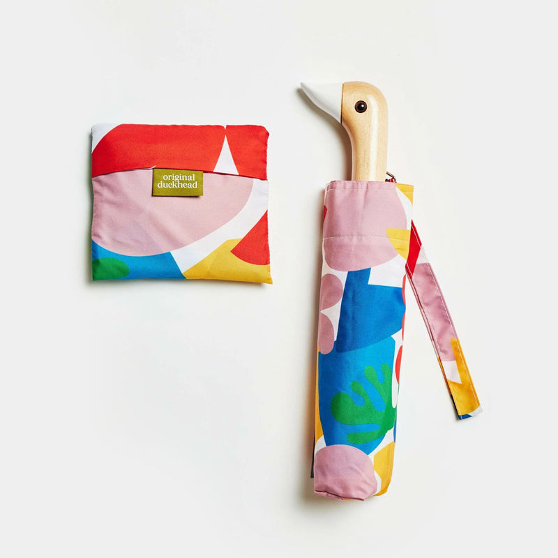 Colorful umbrella with matching pouch on a light background