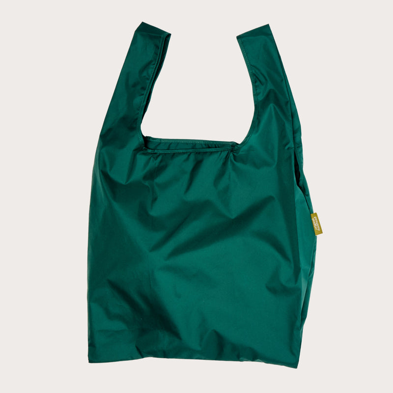 Green reusable bag on a plain background