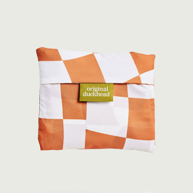 Checkered reusable tote bag in pouch with orange and white pattern