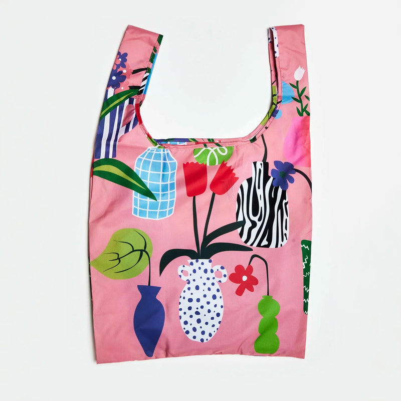 Reusable shopping bag with floral and vases pattern on a pink background