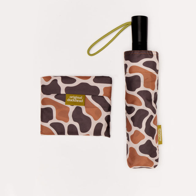 Foldable umbrella and matching pouch with brown and taupe pattern on a white background